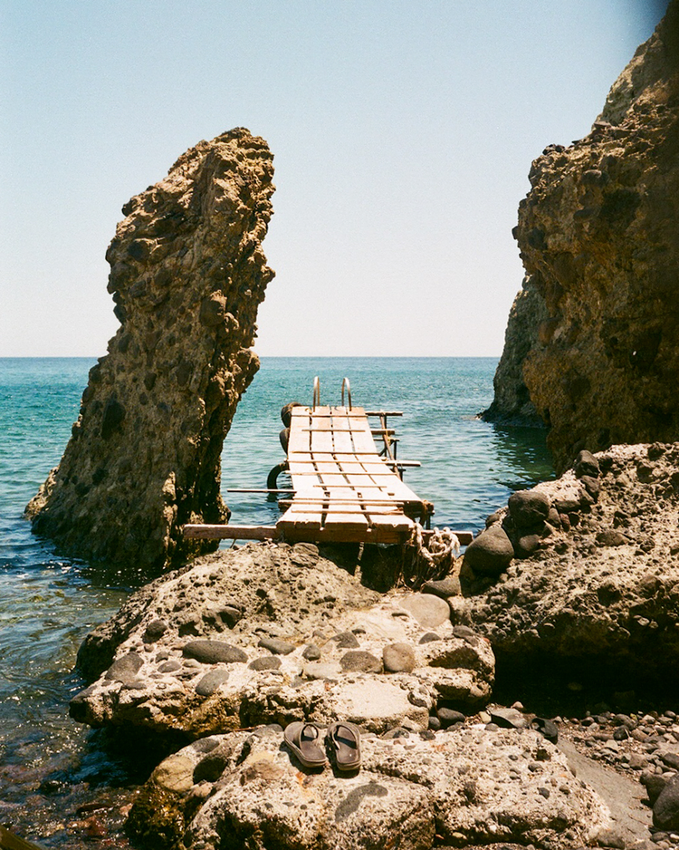 A thrown together pier on a secluded beach.